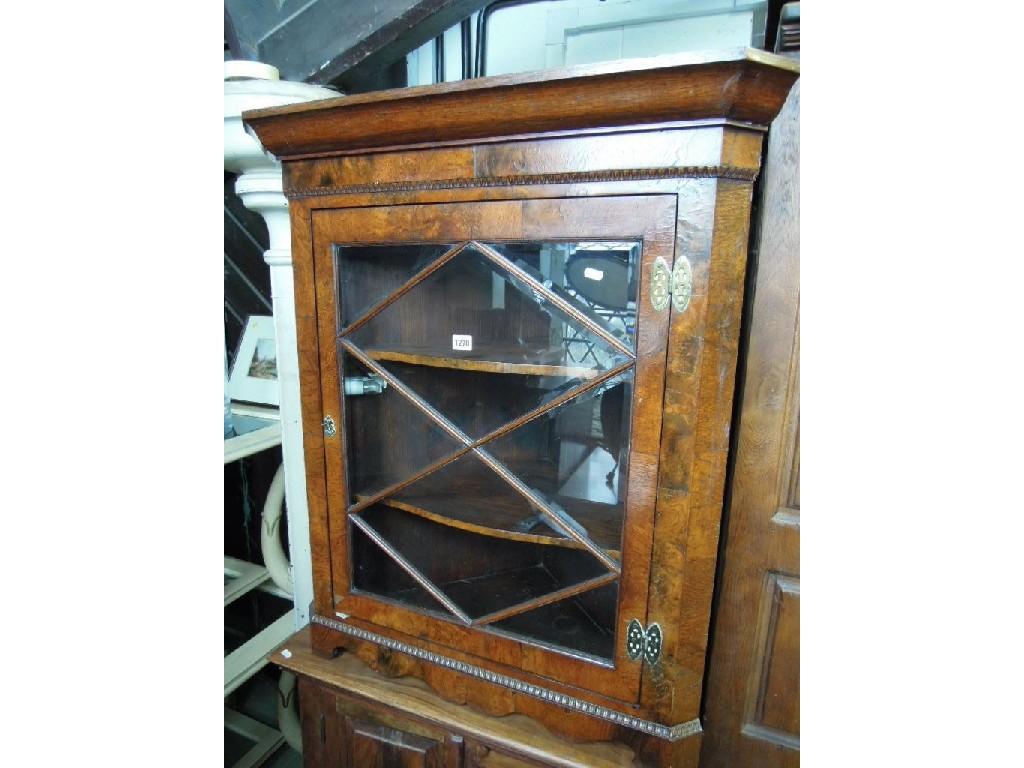 Appraisal: A good quality figured oak corner cabinet with moulded cornice