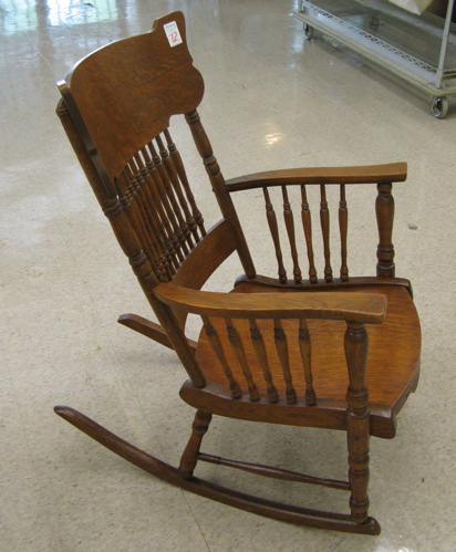 Appraisal: LATE VICTORIAN OAK ROCKING ARMCHAIR American c the back with