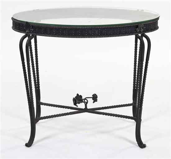 Appraisal: An Iron and Glass Occasional Table of oval form raised