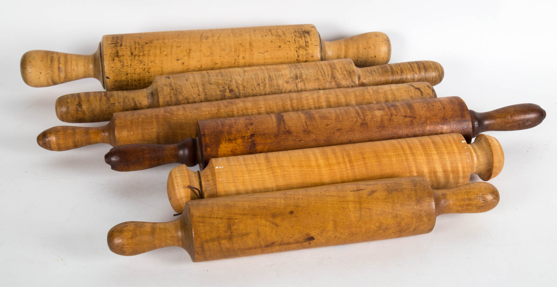 Appraisal: Six antique tiger maple and maple rolling pins th century