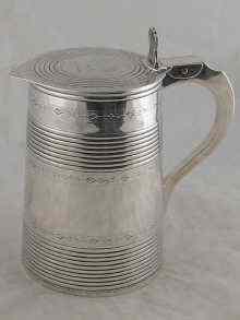 Appraisal: A Georgian silver quart tankard with double ribbed and brightcut