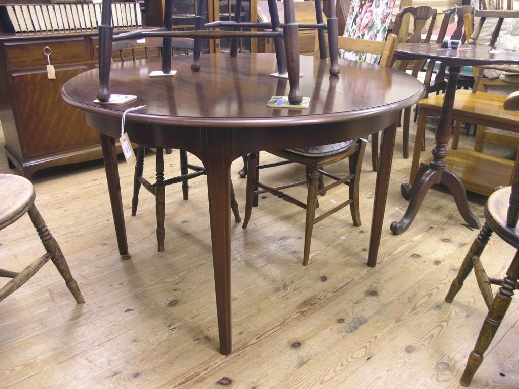 Appraisal: A Stag Minstrel dining table circular-shape with extra leaf ft