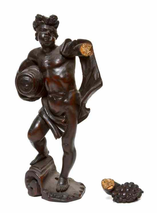 Appraisal: A Continental Carved Wood Bacchic Figure the standing draped male