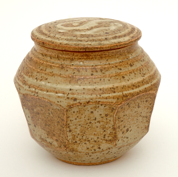 Appraisal: HAROLD HUGHAN Victoria circa Faceted stoneware lidded jar mottled brown