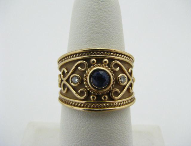 Appraisal: K Yellow gold cigar band style ring with tanzanite