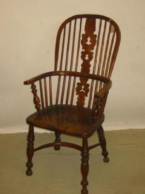 Appraisal: AN ASH AND ELM WINDSOR ARMCHAIR of high hooped form