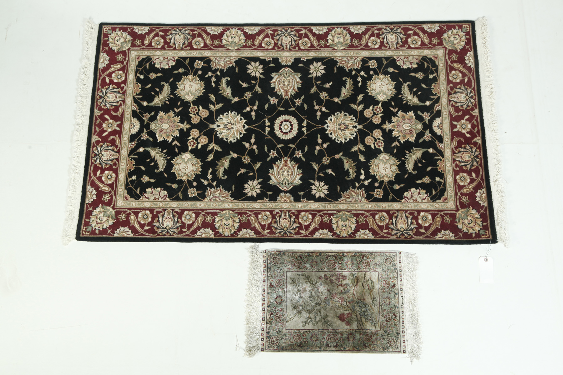 Appraisal: TWO ORIENTAL RUGS Late th century Persian-style with black ground