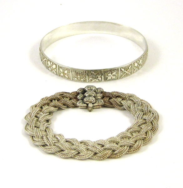 Appraisal: TWO STERLING SILVER BRACELETS including an oval silver bangle and