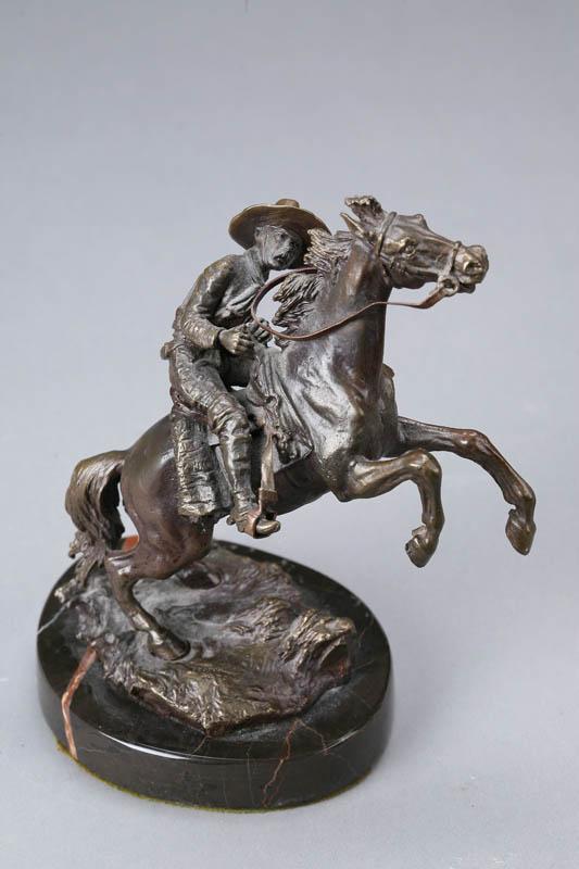 Appraisal: HORSE AND RIDER STATUE Bronze figure of a cowboy on