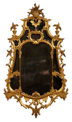 Appraisal: Chippendale style carved and gilt wood mirror with basket finial