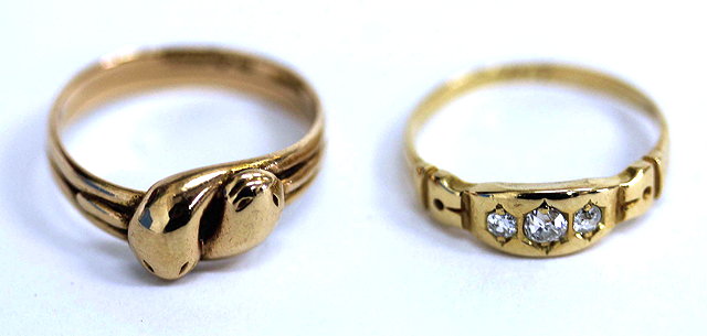 Appraisal: A GOLD CROSSOVER SNAKES HEAD RING together with a further