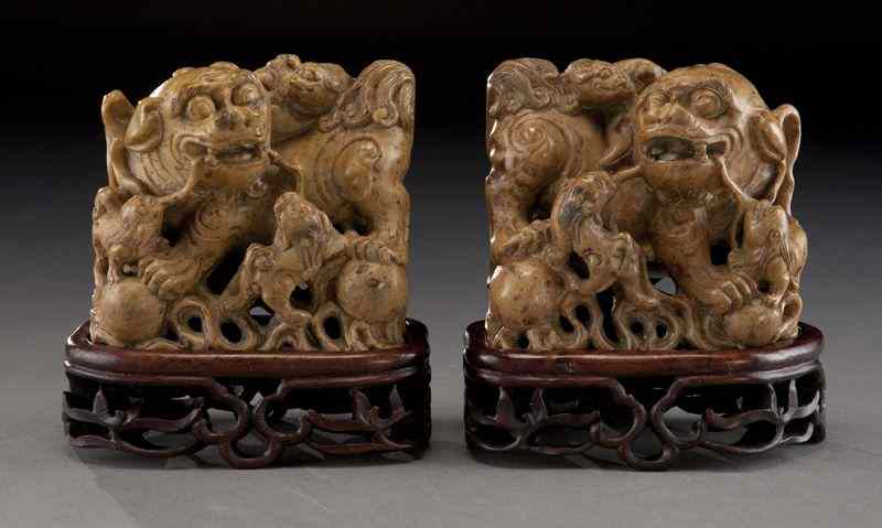 Appraisal: Pr Chinese Qing carved soapstone foo dogs raised on carved