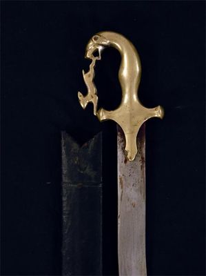 Appraisal: An eastern sword the wavy steel blade with a brass