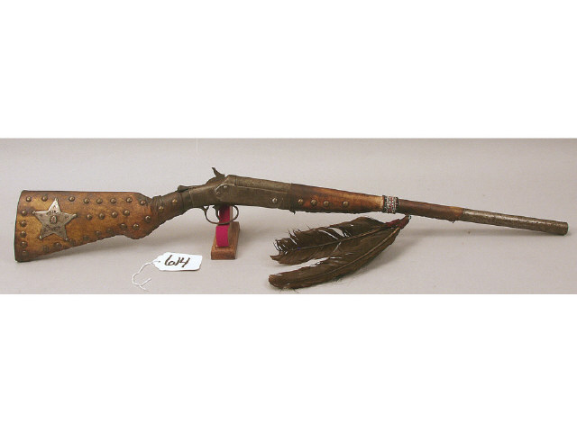 Appraisal: early Indian hide wrapped shotgun tacked decorated with tribal police