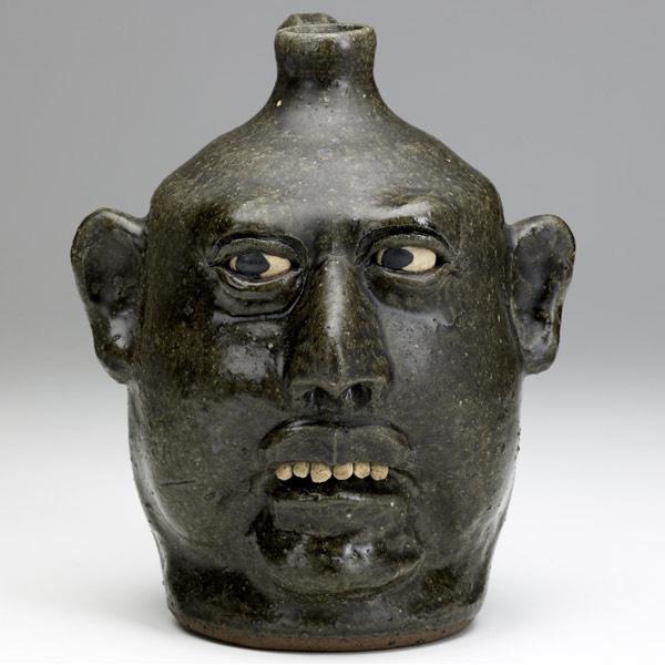 Appraisal: LANIER MEADERS Face jug with clay teeth covered in green