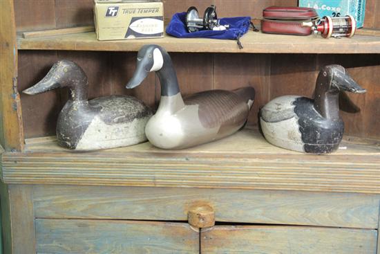 Appraisal: GROUP OF THREE CARVED AND PAINTED DUCK DECOYS Including one