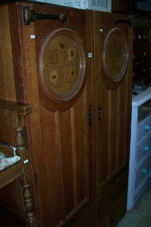 Appraisal: A pair of Arts Crafts oak wardrobe sections by Shapland