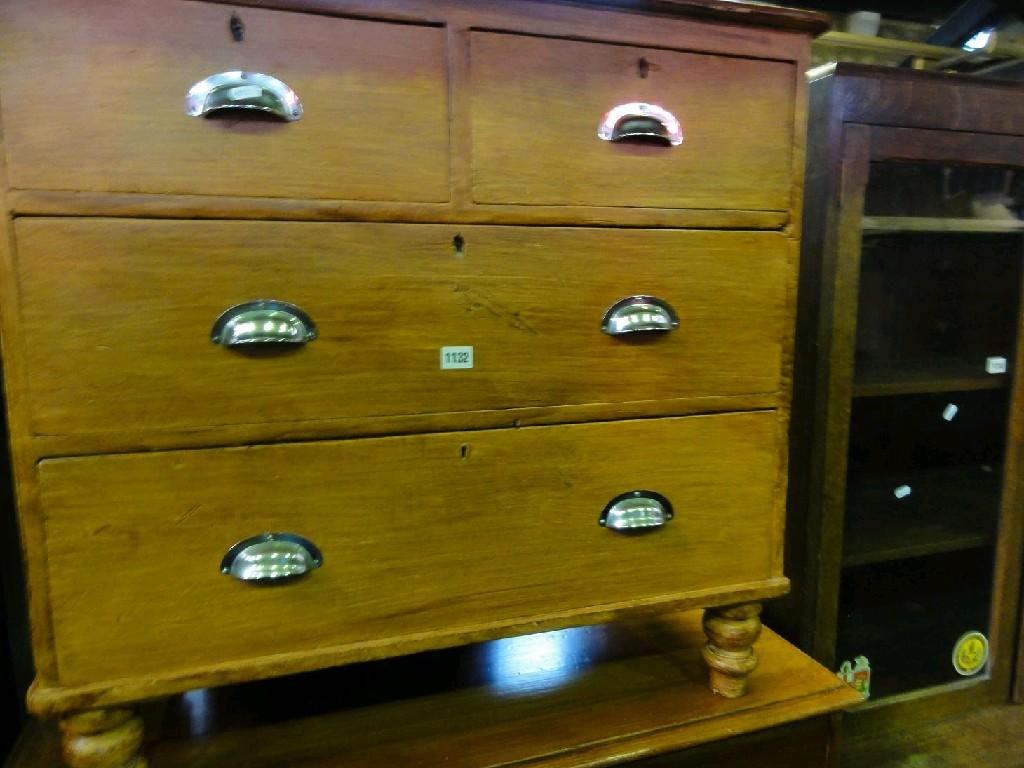 Appraisal: A small Victorian stained pine chest fitted with two long