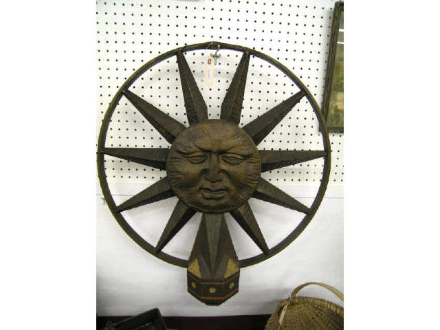 Appraisal: Metal Wood Sculpture with Face ray decor