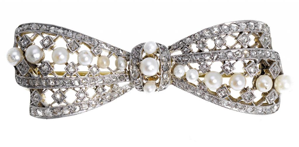 Appraisal: A DIAMOND AND CULTURED PEARL BOW BROOCH in gold