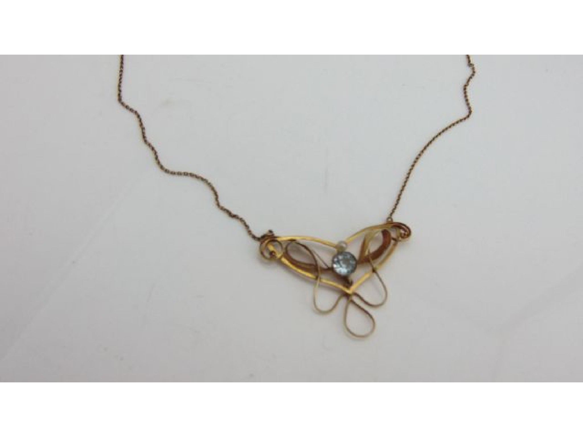 Appraisal: An Art Nouveau style pendant necklace of scrolling form centred