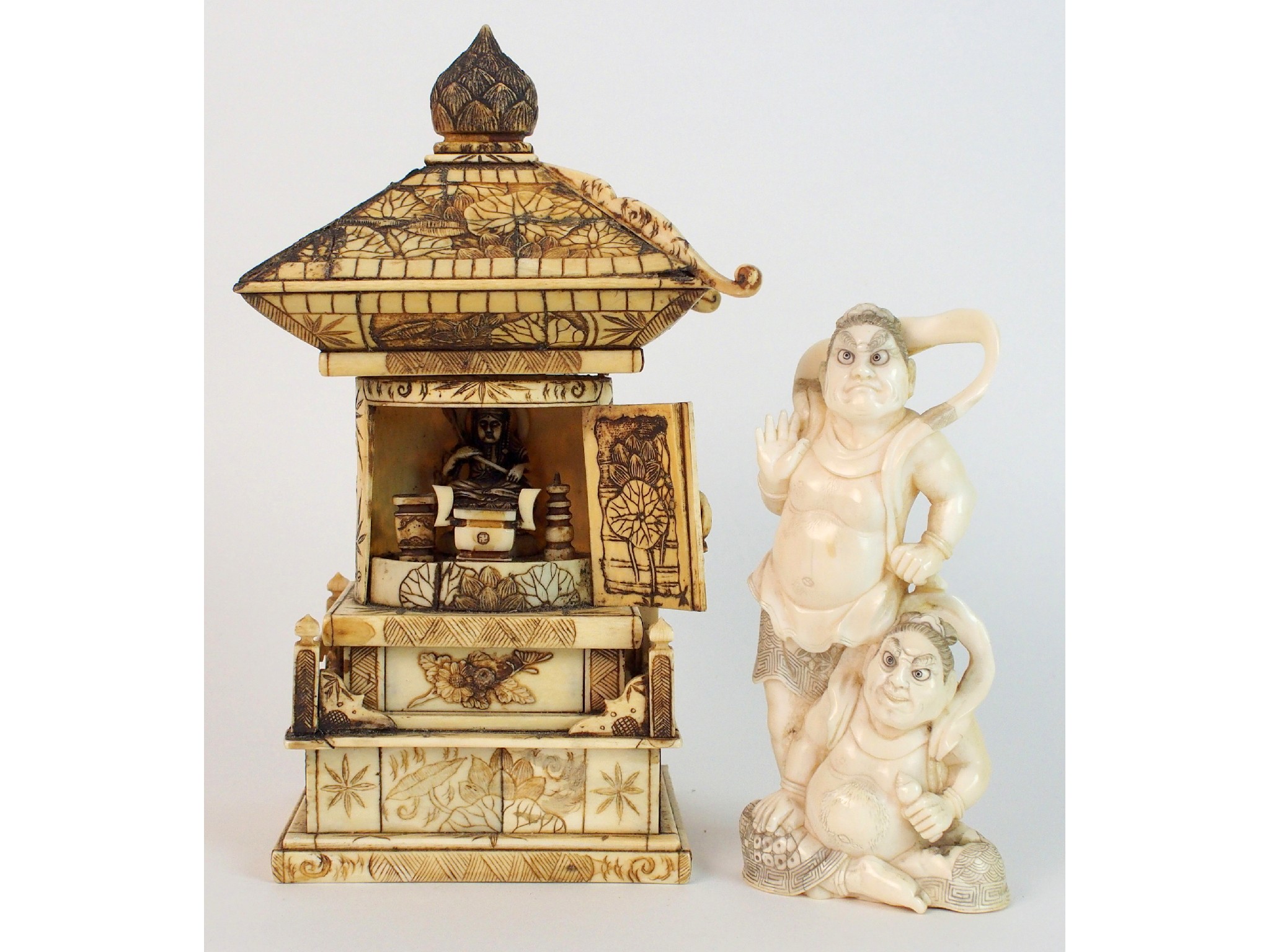 Appraisal: A Japanese ivory okimono of two spiritsone standing the other