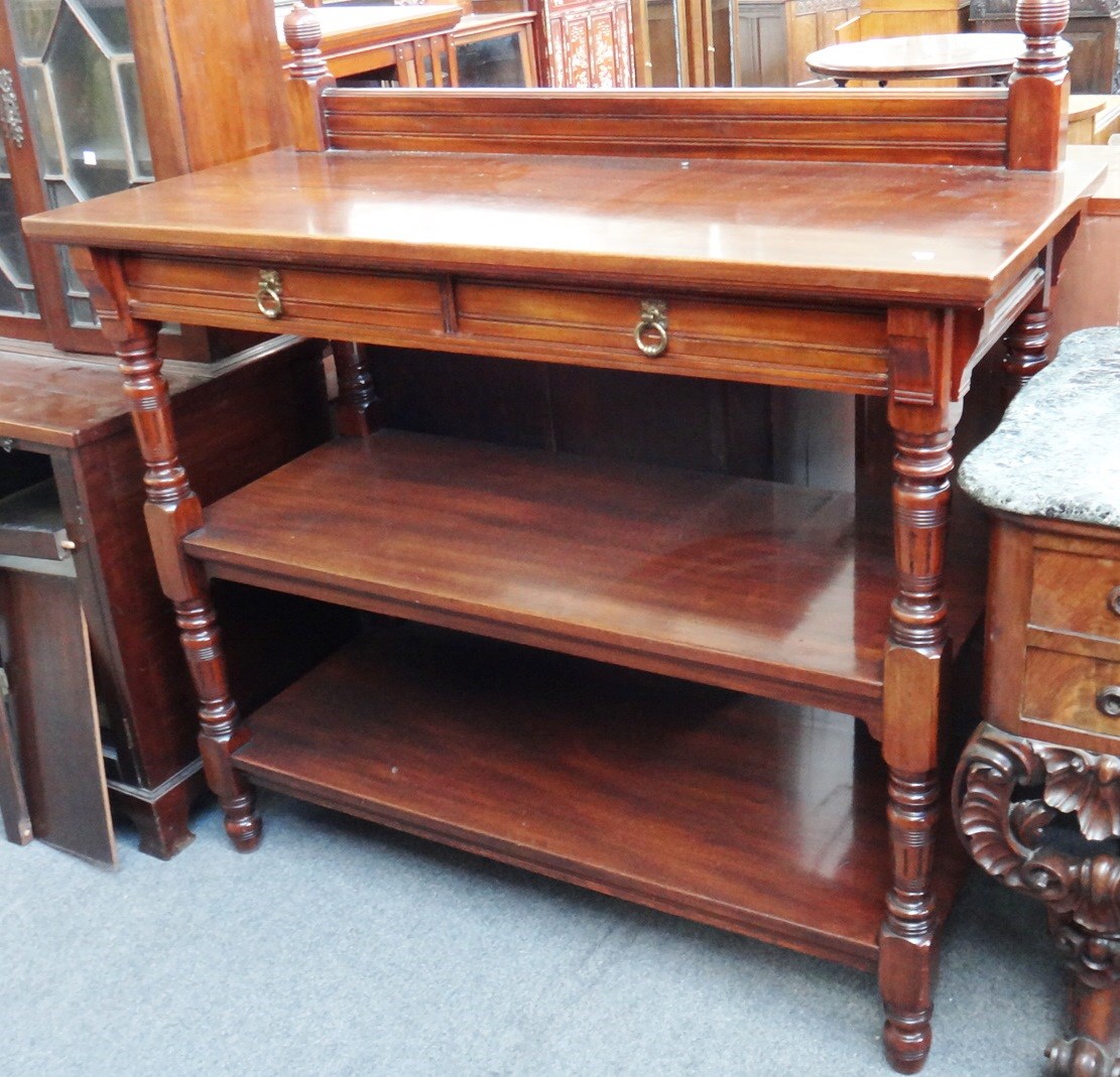 Appraisal: A Victorian walnut three tier buffet the top platform with