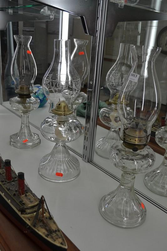 Appraisal: GROUP OF THREE CLEAR GLASS KEROSENE LAMPS