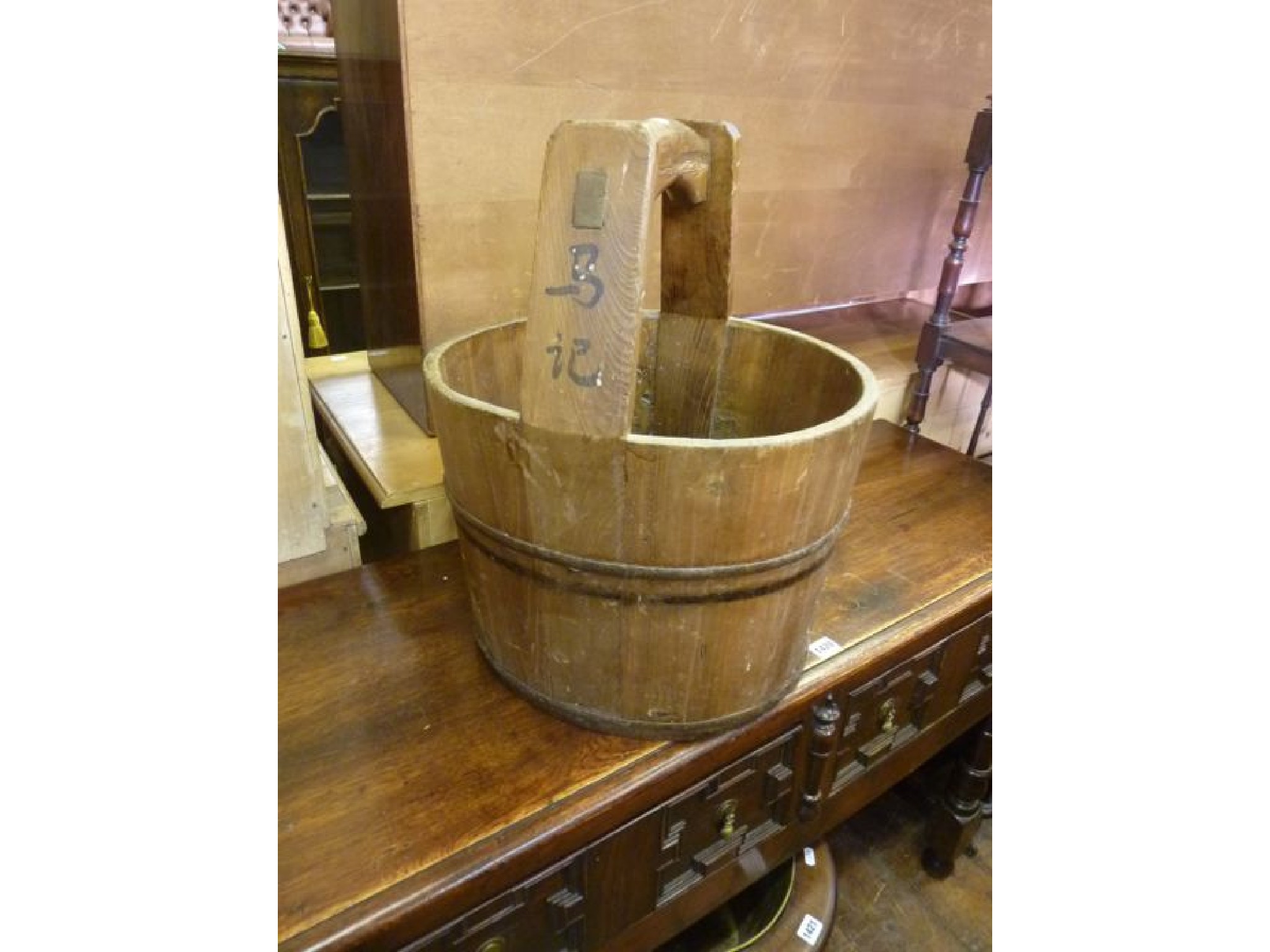 Appraisal: A Chinese pine well bucket with steel banded rim