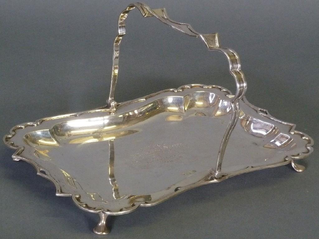 Appraisal: GEORGE V SILVER PRESENTATION SWING HANDLED CAKE BASKET by James