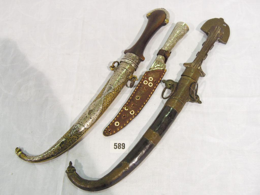 Appraisal: An Indian dagger with silver mounted wooden handle complete with