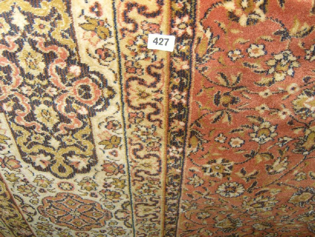 Appraisal: An eastern style wool carpet with stylised floral decoration in