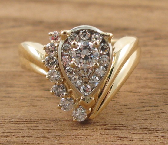 Appraisal: DIAMOND AND FOURTEEN KARAT GOLD RING set with round-cut diamonds