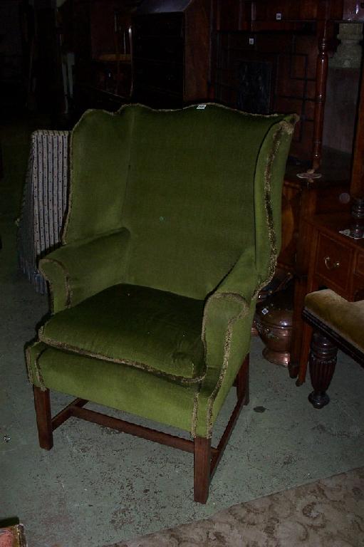 Appraisal: A Georgian wing arm chair with upholstered finish raised on