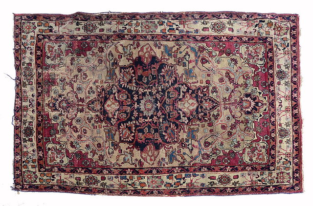 Appraisal: A PERSIAN KIRMAN ROSE PINK GROUND RUG with a central