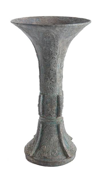 Appraisal: A patinated metal archaistic wine cup together with an Indonesian