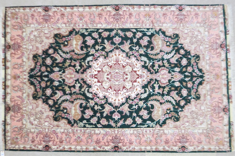 Appraisal: A CONTEMPORARY PERSIAN WOOL AND SILK CARPET floral and central