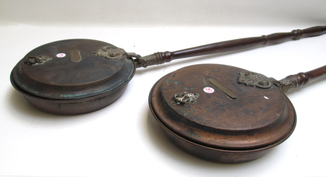 Appraisal: TWO VICTORIAN COPPER BED WARMERS each with wood turned handles