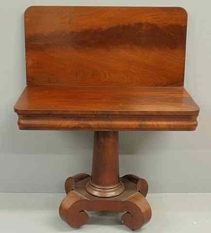 Appraisal: Empire mahogany card table c with flip top and scrolled