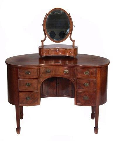 Appraisal: A MAHOGANY KIDNEY-SHAPED KNEEHOLE DRESSING TABLE fitted one central drawer