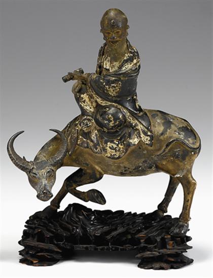 Appraisal: Chinese painted cast bronze figure of a scholar on buffalo