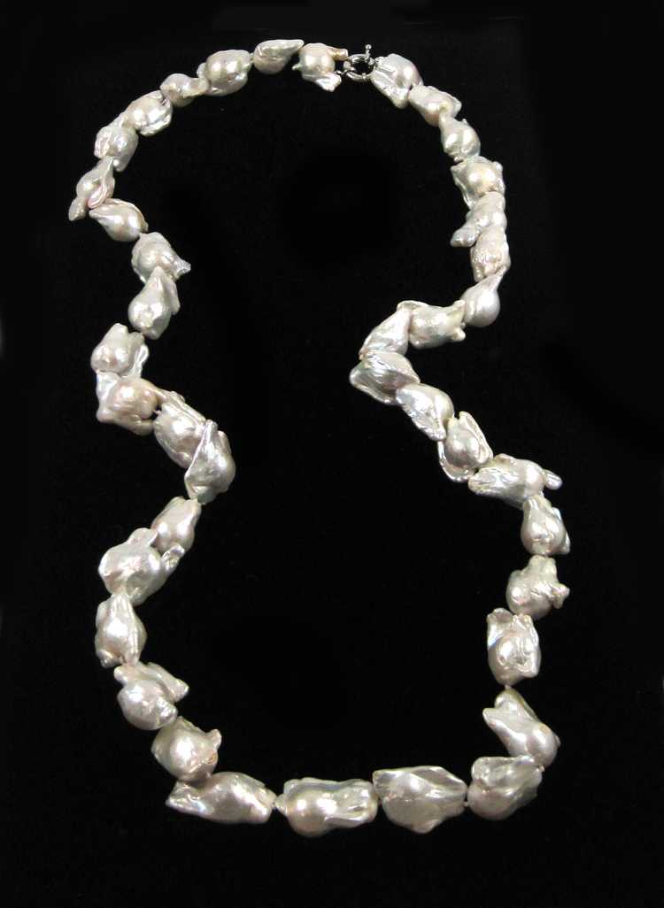 Appraisal: WHITE BAROQUE OPERA LENGTH PEARL NECKLACE having baroque pearls with