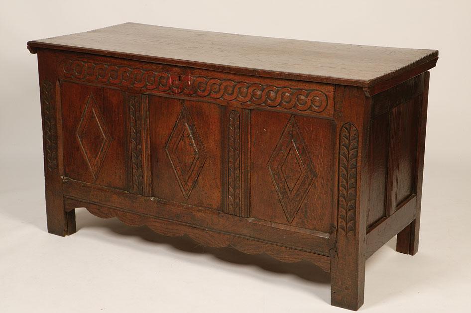 Appraisal: A CHARLES II OAK COFFER the plank construction top with