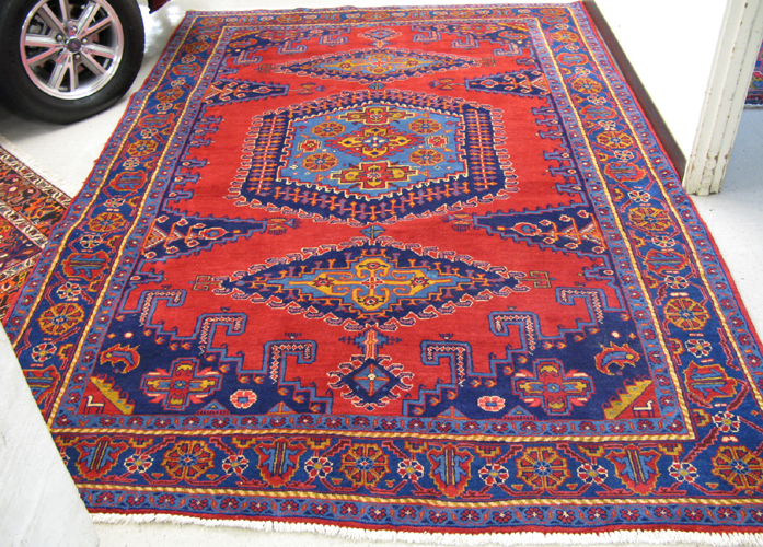 Appraisal: PERSIAN MAHALLAT CARPET multiple geometric medallions on red ground hand