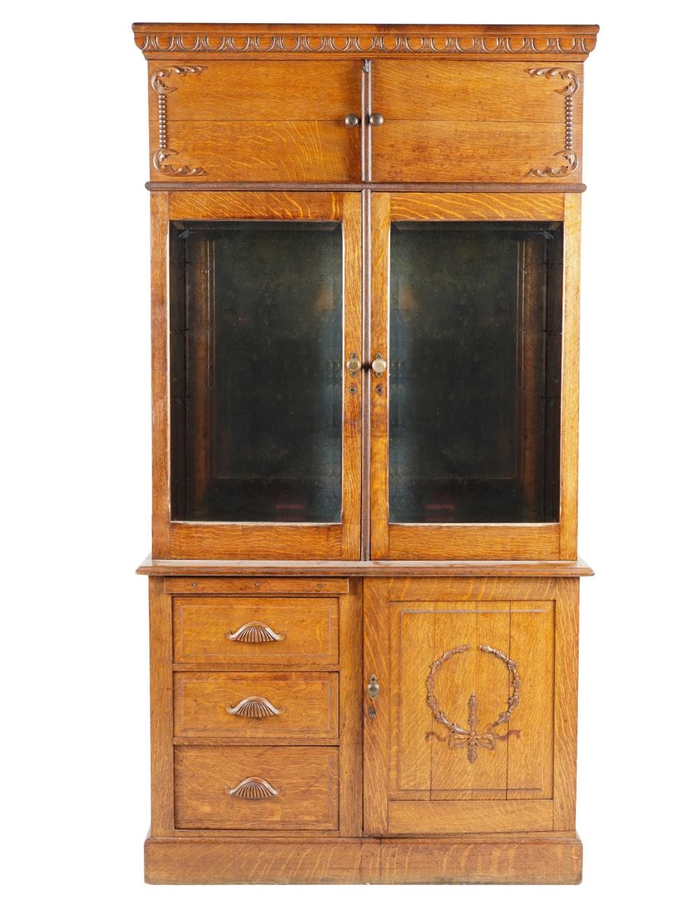 Appraisal: OAK APOTHCARY CABINEThaving hinged glazed doors opening to a pivoting