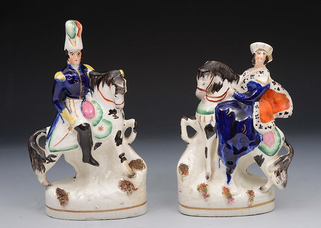 Appraisal: A PAIR OF VICTORIAN STAFFORDSHIRE POTTERY FIGURES of Victoria and