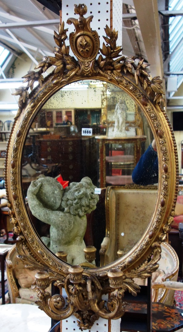 Appraisal: A th century gilt framed oval mirror with floral chased