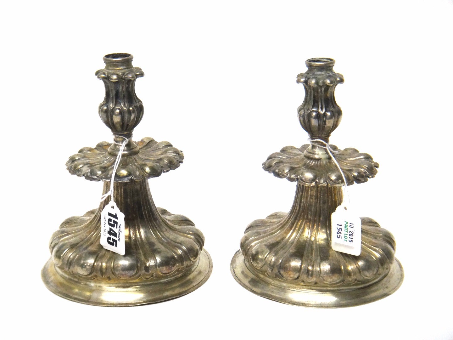 Appraisal: A pair of European silver candlesticks each on a circular