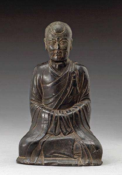 Appraisal: A carved black stone figure of Buddhist monk Ming Dynasty