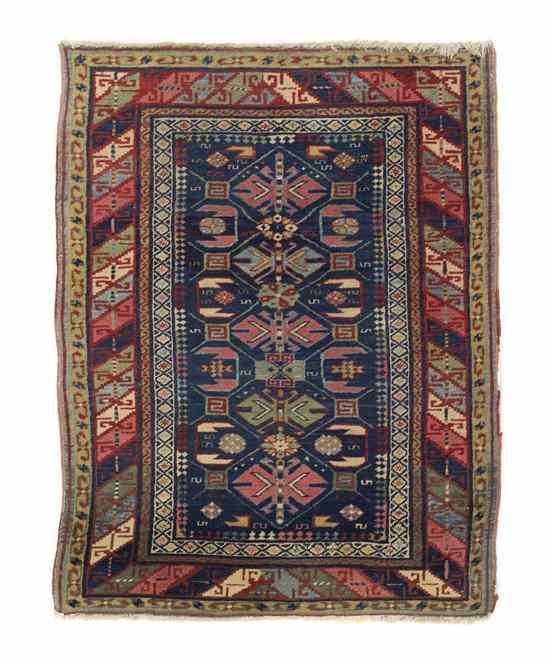 Appraisal: A Persian Wool Rug having repeating geometric medallions on a